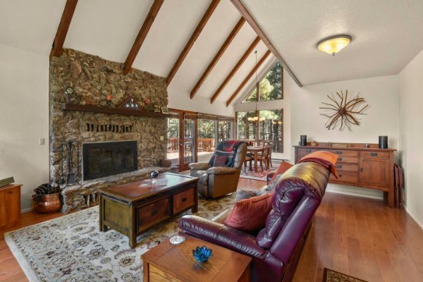 Luxury cabin home with vaulted ceilings and stone fireplace